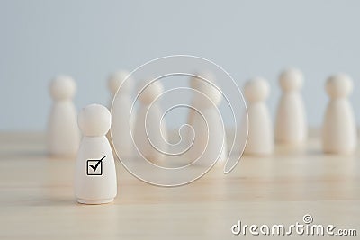 Check mark for Choose figure standing out from the group of crowd. Choice of employee leader from the crowd. Stock Photo