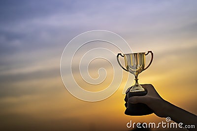 Business hold a trophy showing success until receiving the award Stock Photo