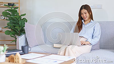 Business at home concept, Businesswoman reads data on laptop to analysis marketing plan of startup Stock Photo