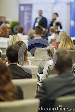 Business Ideas and Concepts. People at the Business Conference Listening to Hosts in Front of the Stage Editorial Stock Photo
