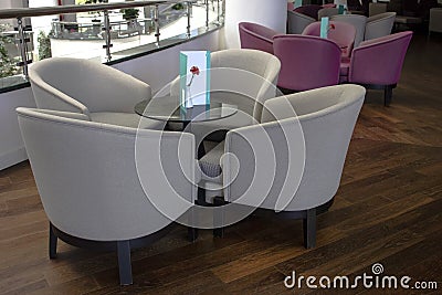 Business Interior. Brown parquet, beige leather sofas and glass Stock Photo