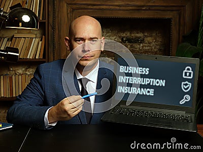 BUSINESS INTERRUPTION INSURANCE phrase on the screen. Marketing expert use internet technologies at office. Concept search and Stock Photo