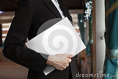 The business lady holds the white magazine Stock Photo