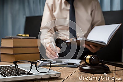 Business lawyer working hard at office desk workplace with book Stock Photo