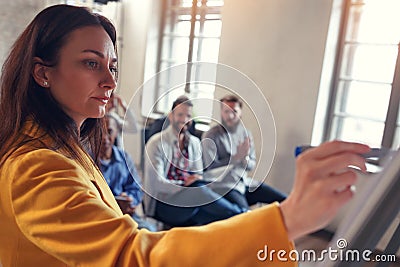 Business leader -woman at board teaches colleagues Stock Photo