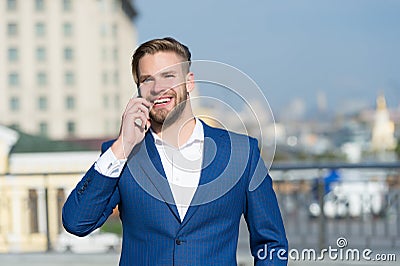 Business lifestyle concept. Happy businessman with smartphone on sunny terrace. Man smile in formal suit with mobile phone outdoor Stock Photo