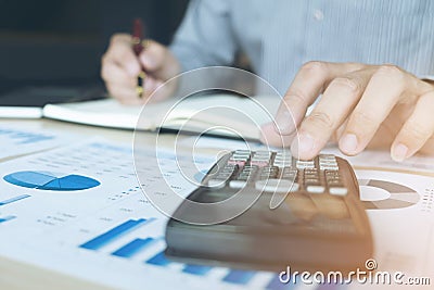 Business man or accountant working Financial investment on calculator with calculate Analyze business and market growth on Stock Photo