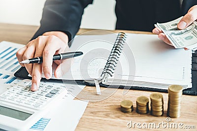 Business man Accounting Calculating Cost Economic budget putting Row and coin Write Finance ,investment and saving concept Stock Photo