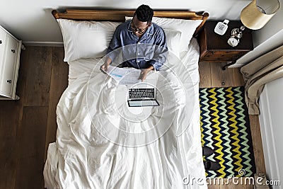 Business man in bed working Stock Photo