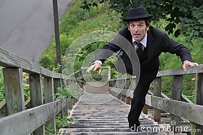 Business man ruining up the stairs or falling down the stairs Stock Photo