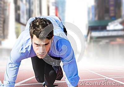 Business man in blue at start line against blurry city Stock Photo