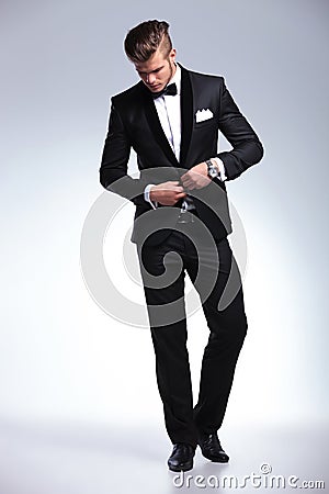 Business man buttoning and looking down Stock Photo