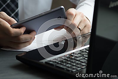 Business man drinking coffee and using laptop computer and mobil Stock Photo