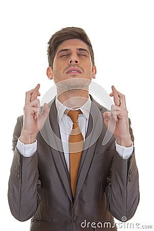 Business man fingers crossed eyes closed Stock Photo