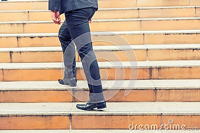 Business man going up the stairs in a rush hour to work. Hurry time Stock Photo