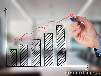 Business man hand drawing a graph Stock Photo