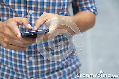 Business man hand using mobile smart phone. Close up mid section man well dressed holding phone typing text messaging. Phone Stock Photo