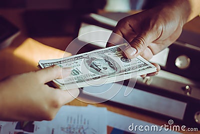 Business man handing money over a business dealing Stock Photo