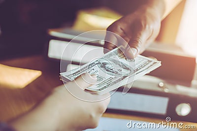 Business man handing money over a business dealing Stock Photo