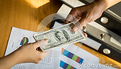 Business man hands handing money over a business deal Stock Photo