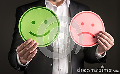 Business man with happy smiling and sad unhappy faces. Stock Photo