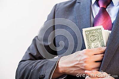 Business man hiding money in jacket pocket Stock Photo