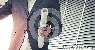 Business man holding construction plan for contractor concept Stock Photo