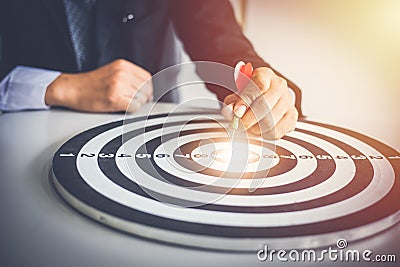 Business man holding dart hits Bullseye is a target and goal of business marketing as concept Stock Photo