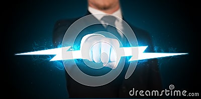 Business man holding glowing lightning bolt in his hands Stock Photo