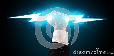 Business man holding glowing lightning bolt in his hands Stock Photo