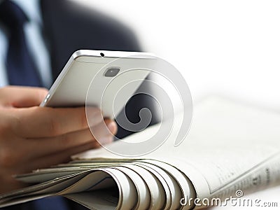 Business man holding a newspaper and a smart phone in his hand. The white background image Stock Photo