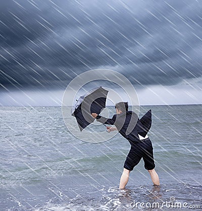 Business man holding a umbrella to resist rainstorm Stock Photo