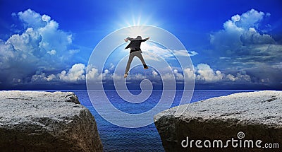 Business man jumping to next cliff with risk decision Stock Photo