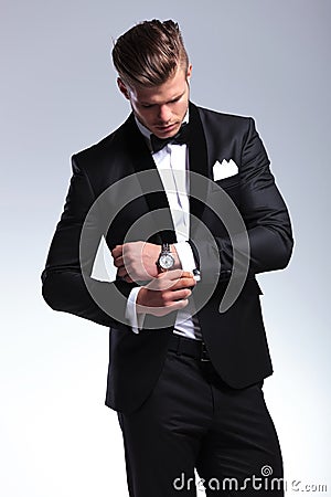 Business man looks at his cufflinks Stock Photo