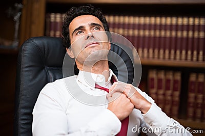 Business man loosing his necktie Stock Photo