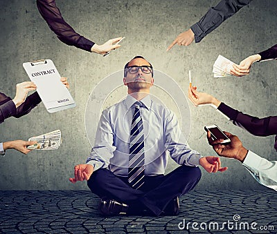 Business man is meditating to relieve stress of busy corporate life Stock Photo