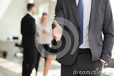 A business man with an open hand ready to seal a deal. Stock Photo