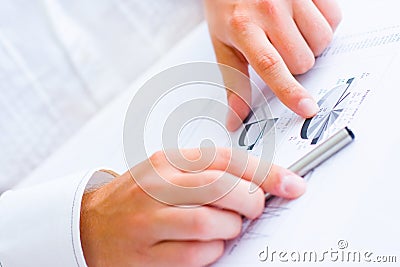 Business man pointing to charts and graphs Stock Photo