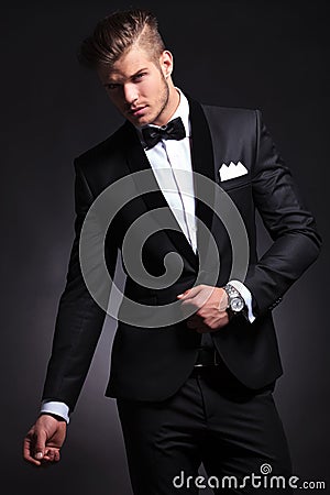 Business man posing with hand on tuxedo jacket Stock Photo