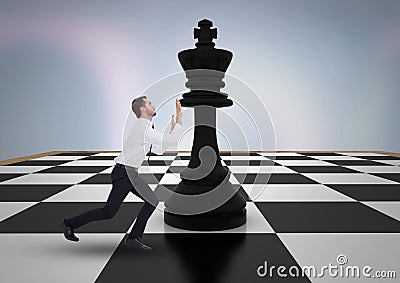 Business man pushing chess piece against purple abstract background Stock Photo