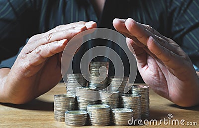 Business man protection coins for his money all in finance accounting concept. Stock Photo