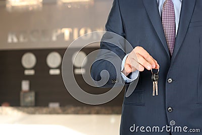 Business man at the reception giving keys Stock Photo