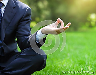 Business man relax in a park in the lotus position Stock Photo