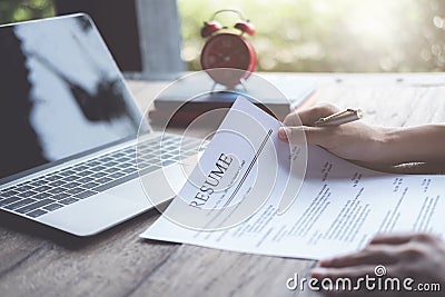 Business man review his resume application on desk, laptop computer, job seeker Stock Photo