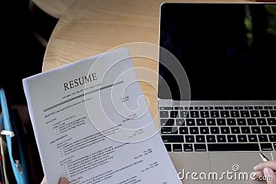 Business man review his resume application on desk, laptop computer, job seeker Stock Photo