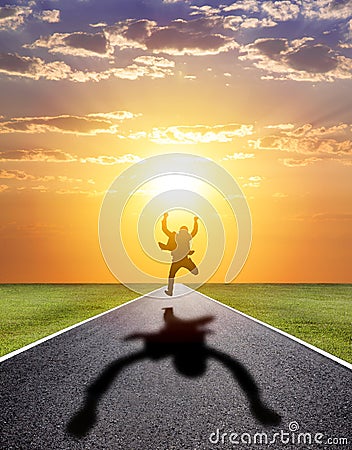 Business man running happily to successful road with sunset Stock Photo