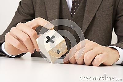 a business man& x27;s hand holds a wooden cube block to change minus sign to plus sign on white background. positive Stock Photo