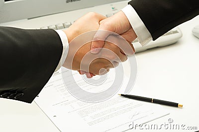 Business man shake hands after signing a contract Stock Photo