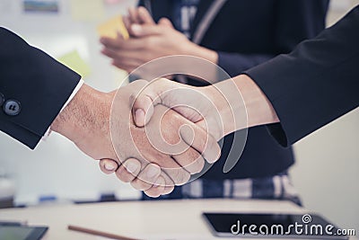 Business man shaking hand with woman clapping Stock Photo