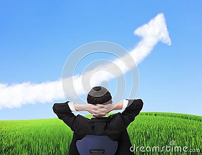 Business man sit on chair and watch growth cloud Stock Photo